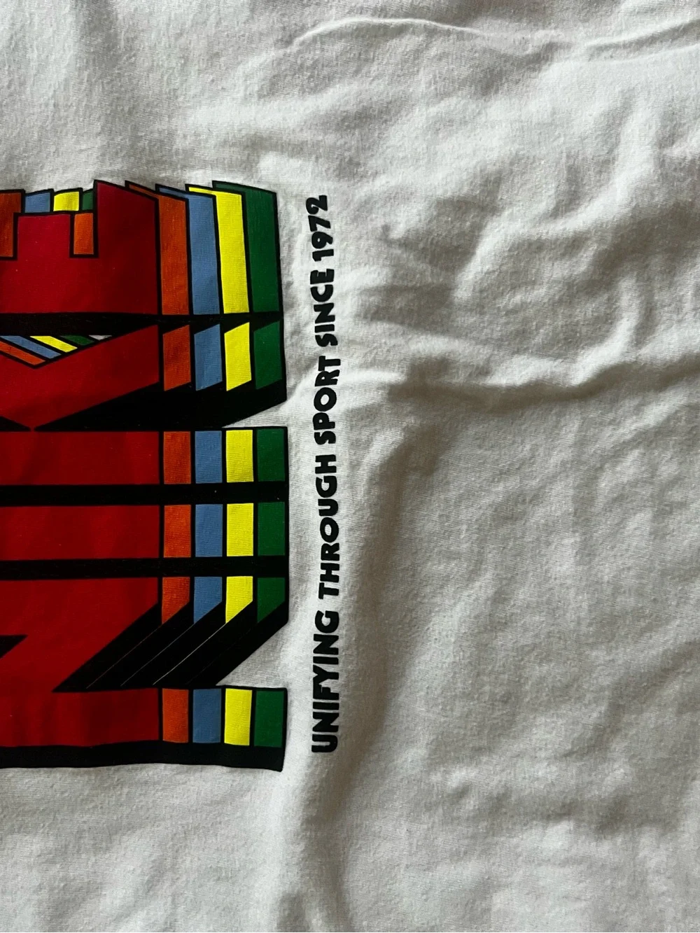 Nike White Tee with Red Logo and Rainbow Stripes
